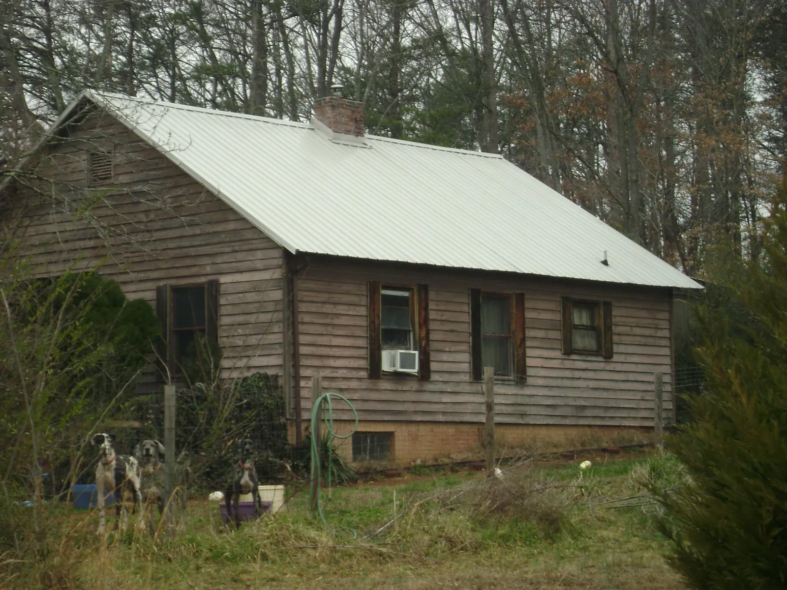 White metal roof on an old wood sided farmhouse, from a Metal Roof Installation job in Barnard